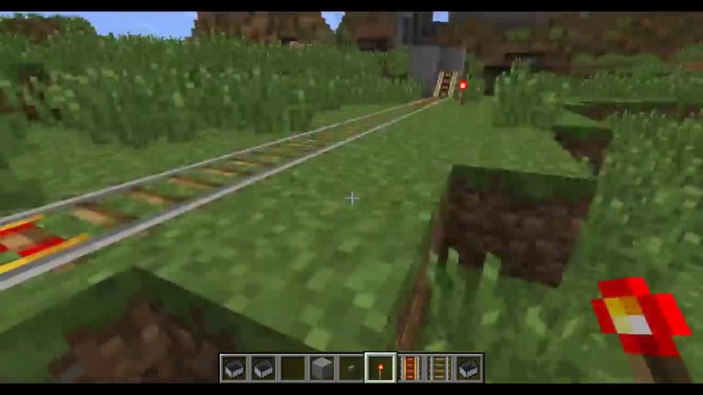 An illustration showing the crafting process of powered rails in Minecraft.