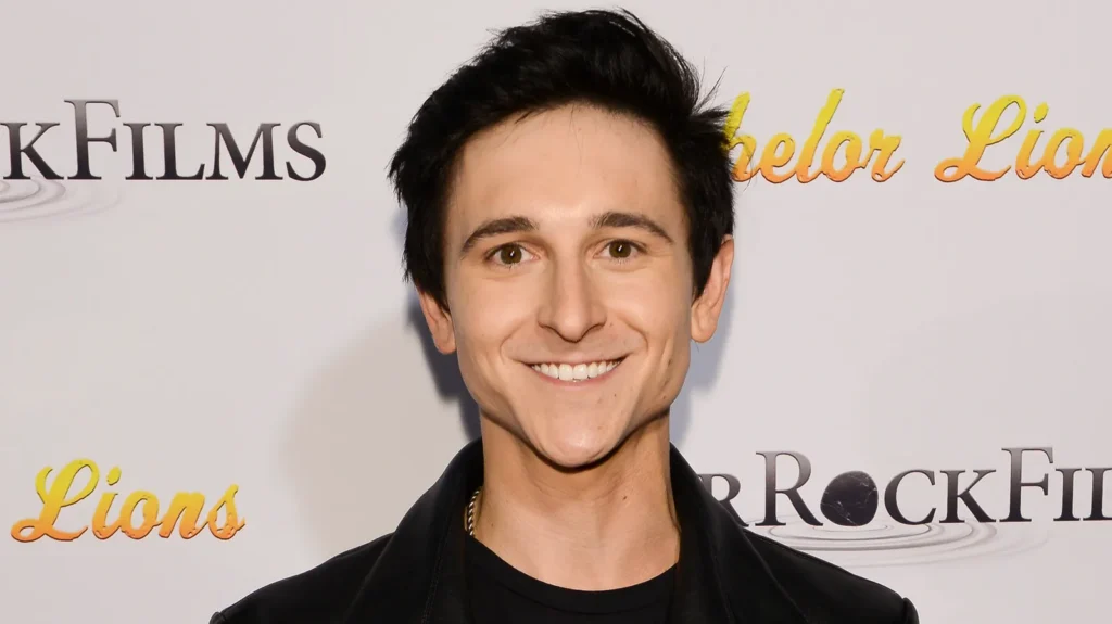 Mitchel Musso with a thoughtful expression symbolizing his complex identity and career journey