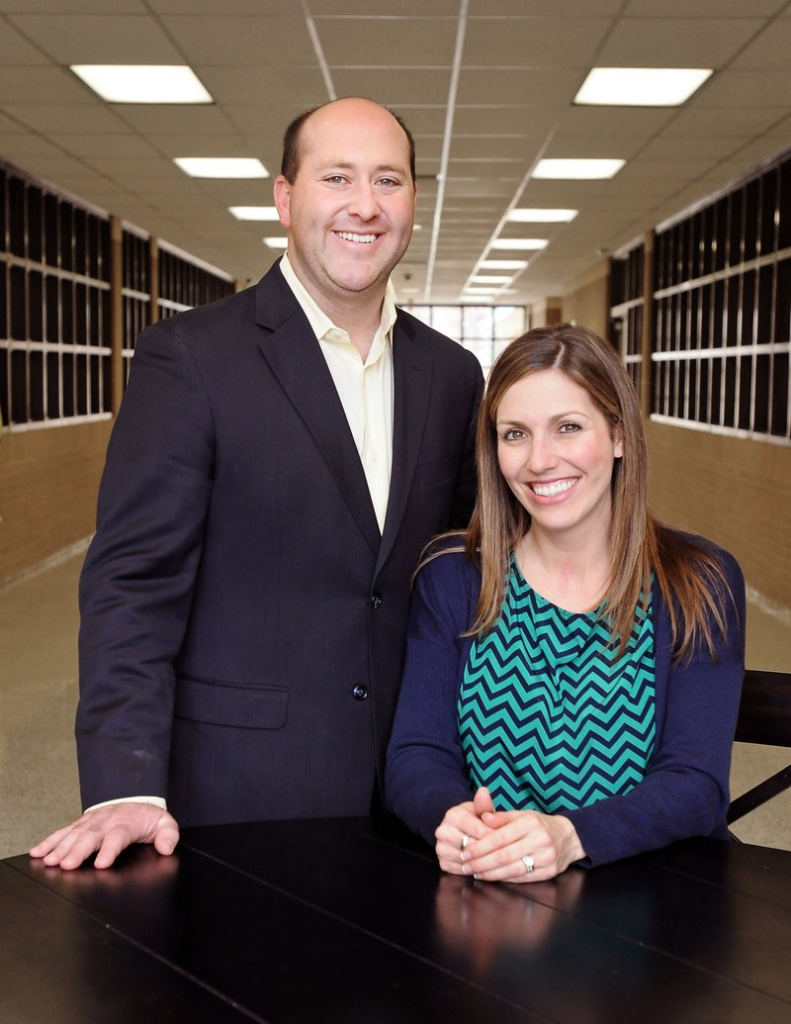 Patrick Woodruff and his wife Meredith pose at Elmwood Middle School in Rogers